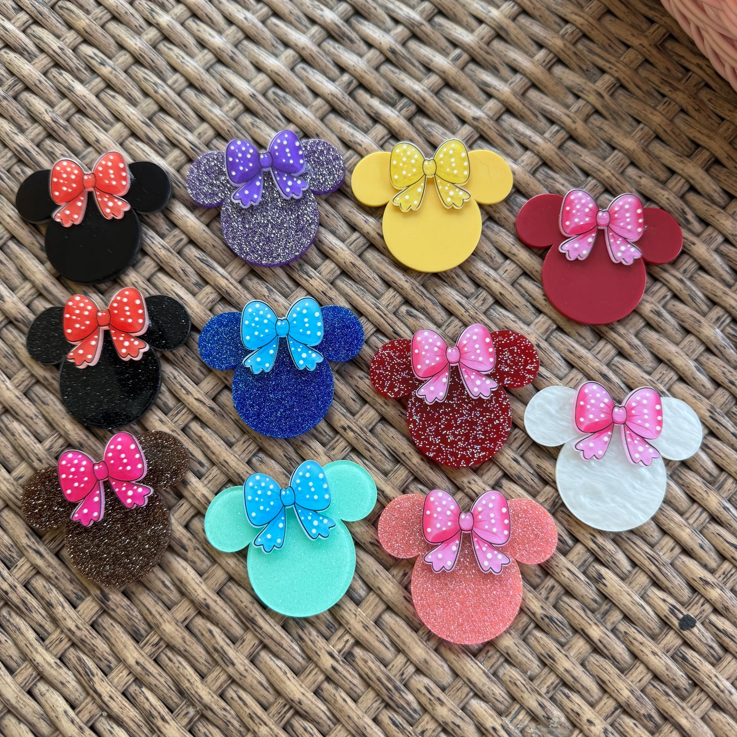 Colorful hair accessories with polka dot designs on a woven surface